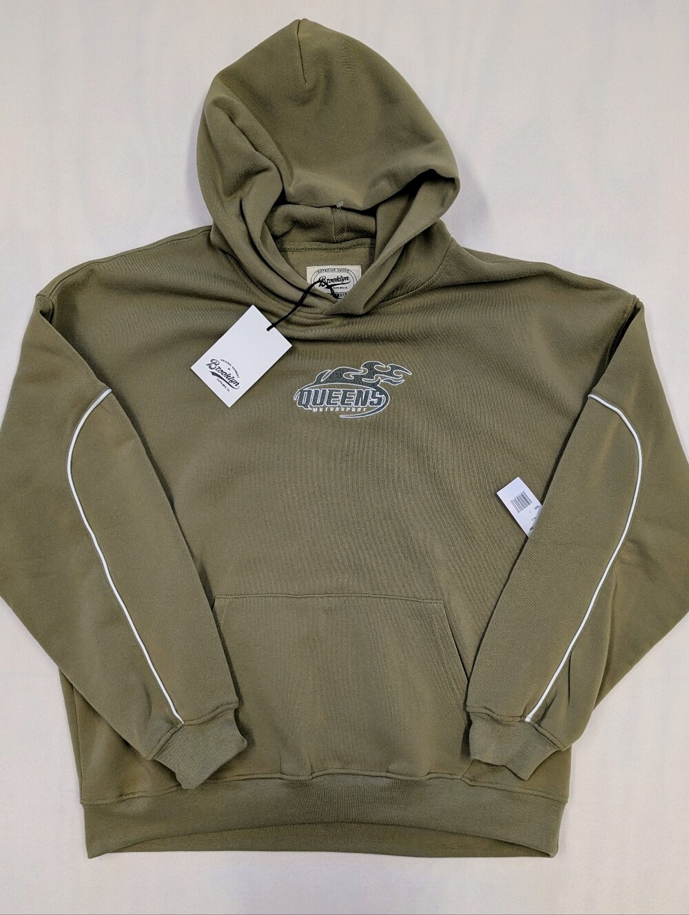 Brooklyn brand olive green hoodie with contrast piping and a Queens motorsport